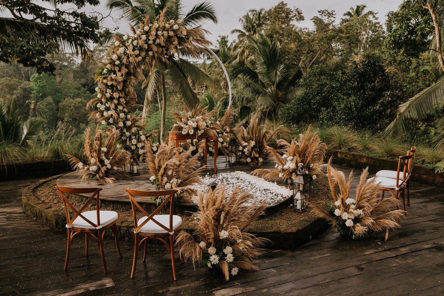 Wedding table set among pampas and white flowers on the terrace, above the jungle